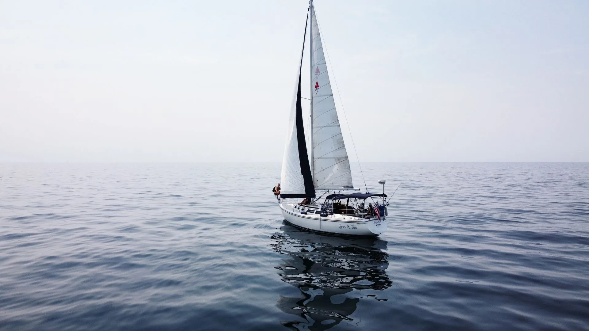 Sailboat under sail on calm open water