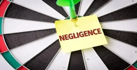A dart pierces a sticky note labeled "NEGLIGENCE" on a dartboard, underscoring what you need to know about Michigan's laws.