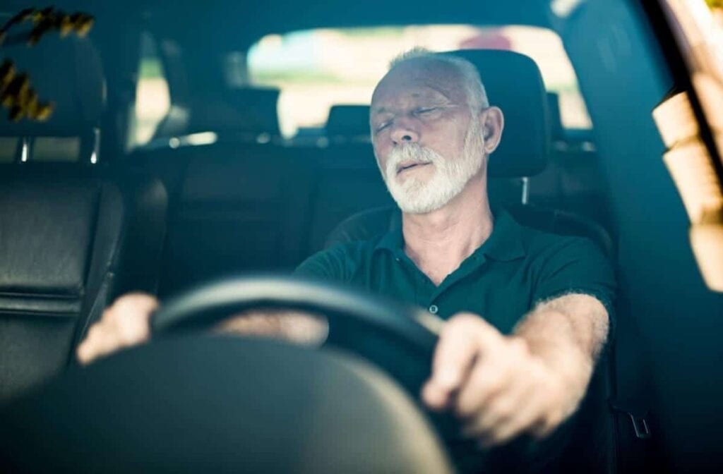 An elderly motorist with a white beard was found slumped behind the wheel, having apparently fallen asleep.
