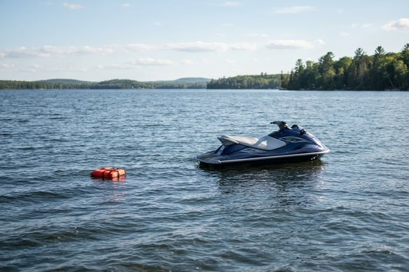 Unattended jet ski drifting on a lake with a life vest nearby, representing jet ski accidents